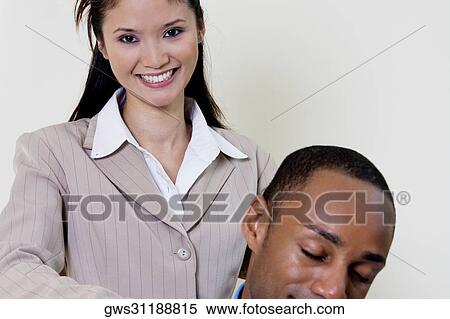 Businesswoman standing behind a businessman View Large Photo Image Stock Photography - Businesswoman standing behind a businessman. Fotosearch