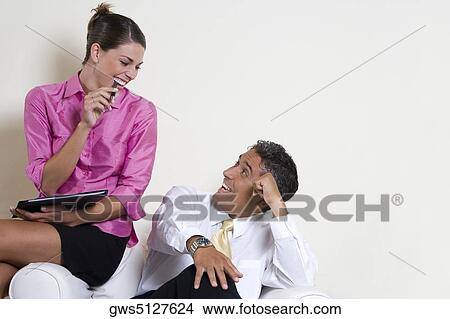 Picture - Businesswoman talking to a businessman. Fotosearch
