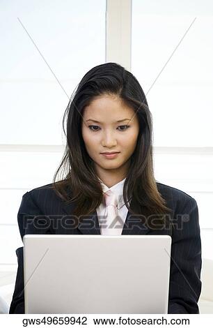Businesswoman using on a laptop View Large Photo Image Stock Image - Businesswoman using on a laptop. Fotosearch