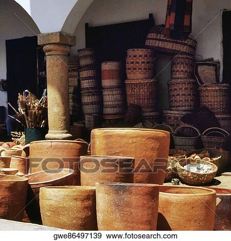 Clay pots and wicker baskets for sale at a market stall View Large Photo Image Stock Photo - Clay pots and wicker baskets for sale at a market stall. Fotosearch