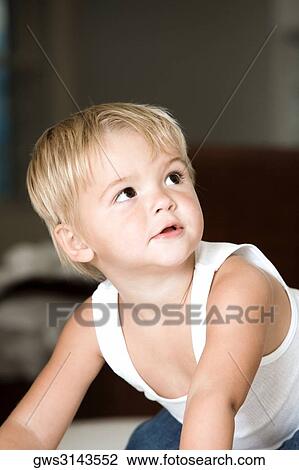 Stock Image - Close-up of a boy crawling on the floor. Fotosearch