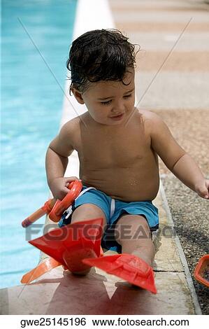 Close-up of a boy holding snorkel sitting by the pool View Large Photo Image Stock Photograph - Close-up of a boy holding snorkel sitting by the pool. Fotosearch