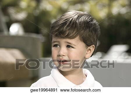 Close-up of a boy looking sad View Large Photo Image Stock Image - Close-up of a boy looking sad. Fotosearch