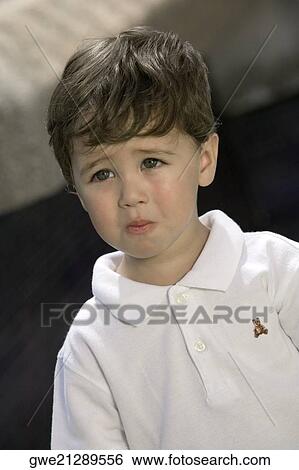 Close-up of a boy looking sad View Large Photo Image Stock Photograph - Close-up of a boy looking sad. Fotosearch