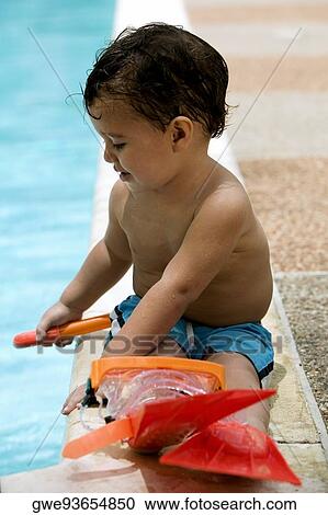 Close-up of a boy sitting by the pool View Large Photo Image Stock Image - Close-up of a boy sitting by the pool. Fotosearch