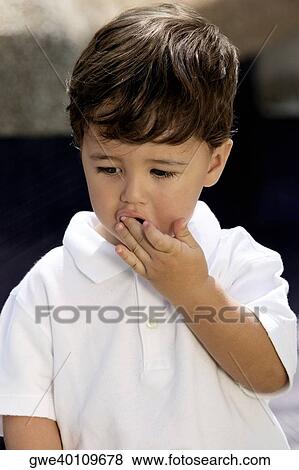 Close-up of a boy with his hand covered his mouth View Large Photo Image Stock Photo - Close-up of a boy with his hand covered his mouth. Fotosearch