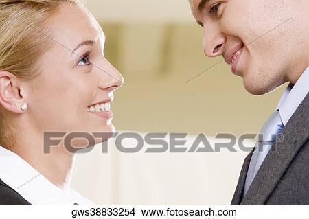 Close-up of a businessman and a businesswoman face to face View Large Photo Image Picture - Close-up of a businessman and a businesswoman face to face. Fotosearch