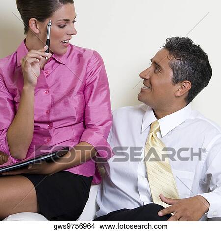 Close-up of a businessman and a businesswoman looking at each other View Large Photo Image Picture - Close-up of a businessman and a businesswoman looking at each other. Fotosearch