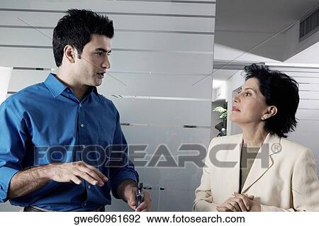 Close-up of a businessman and a businesswoman discussing View Large Photo Image Stock Image - Close-up of a businessman and a businesswoman discussing. Fotosearch