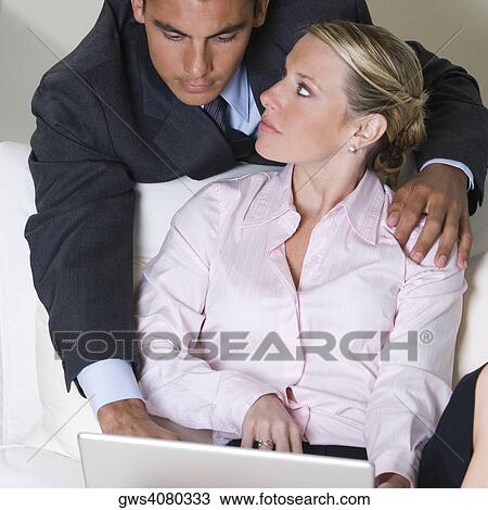Close-up of a businessman and a businesswoman using a laptop View Large Photo Image Stock Image - Close-up of a businessman and a businesswoman using a laptop. Fotosearch
