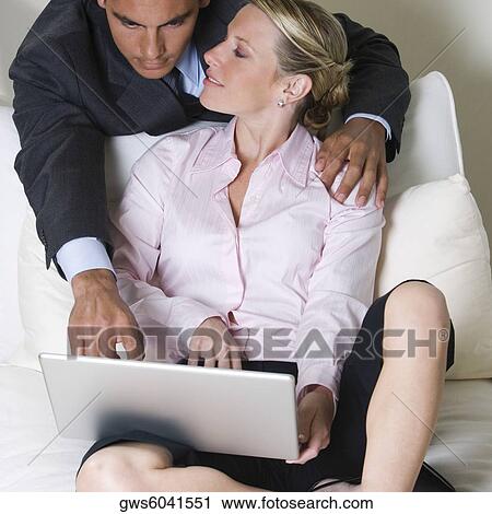Close-up of a businessman and a businesswoman using a laptop View Large Photo Image Stock Image - Close-up of a businessman and a businesswoman using a laptop. Fotosearch