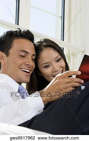 Close-up of a businessman and a businesswoman reading a magazine View Large Photo Image Stock Image - Close-up of a businessman and a businesswoman reading a magazine. Fotosearch