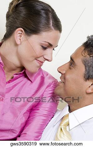 Close-up of a businessman and a businesswoman looking at each other View Large Photo Image Stock Photo - Close-up of a businessman and a businesswoman looking at each other. Fotosearch
