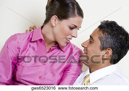 Close-up of a businessman and a businesswoman looking at each other View Large Photo Image Stock Photograph - Close-up of a businessman and a businesswoman looking at each other. Fotosearch