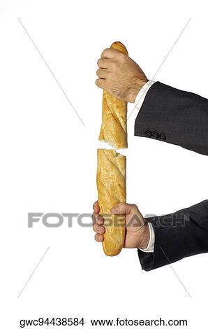Picture - Close-up of a businessman breaking a loaf of bread. Fotosearch