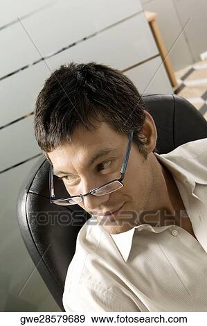 Stock Photo - Close-up of a businessman grinning. Fotosearch