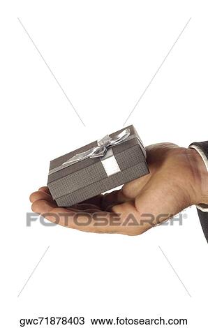 Stock Image - Close-up of a businessman holding a gift. Fotosearch