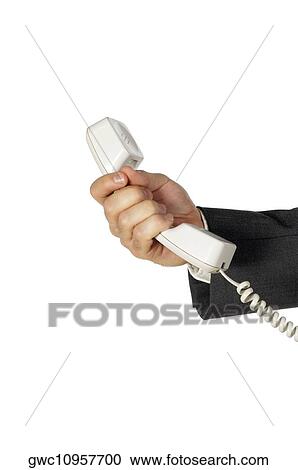 Stock Image - Close-up of a businessman holding a telephone receiver. Fotosearch