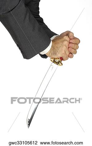 Stock Image - Close-up of a businessman holding a sword. Fotosearch