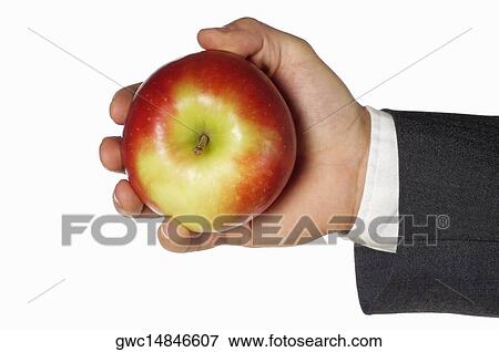 Close-up of a businessman holding an apple View Large Photo Image Stock Photo - Close-up of a businessman holding an apple. Fotosearch