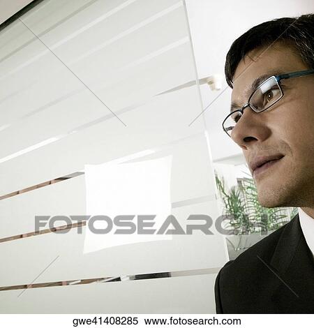 Close-up of a businessman in an office View Large Photo Image Stock Photography - Close-up of a businessman in an office. Fotosearch