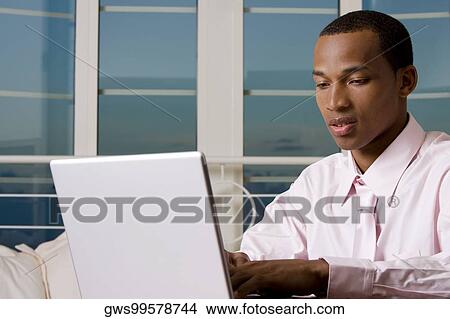 Close-up of a businessman in front of a laptop View Large Photo Image Picture - Close-up of a businessman in front of a laptop. Fotosearch