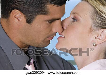 Close-up of a businessman kissing a businesswoman View Large Photo Image Picture - Close-up of a businessman kissing a businesswoman. Fotosearch