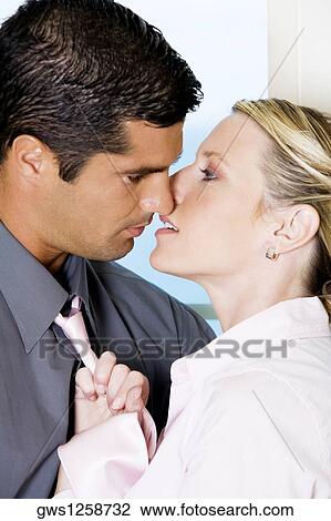 Close-up of a businessman kissing a businesswoman View Large Photo Image Stock Image - Close-up of a businessman kissing a businesswoman. Fotosearch