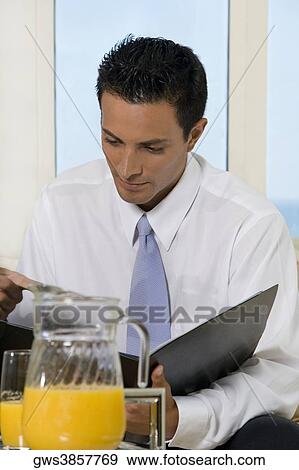 Close-up of a businessman reading a file View Large Photo Image Stock Photo - Close-up of a businessman reading a file. Fotosearch