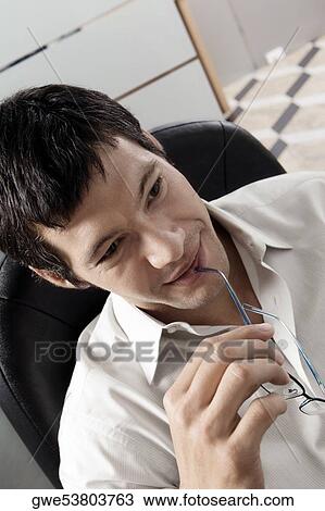 Close-up of a businessman smiling View Large Photo Image Stock Image - Close-up of a businessman smiling. Fotosearch