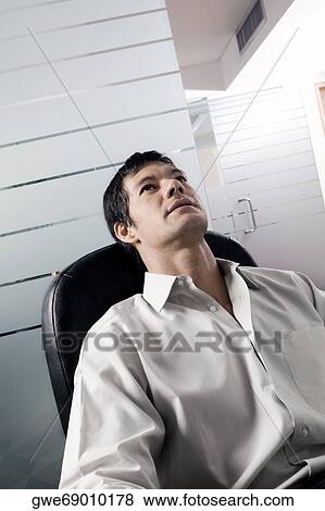 Close-up of a businessman thinking View Large Photo Image Stock Photo - Close-up of a businessman thinking. Fotosearch