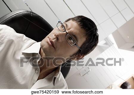 Close-up of a businessman thinking View Large Photo Image Stock Photo - Close-up of a businessman thinking. Fotosearch