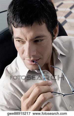 Close-up of a businessman thinking View Large Photo Image Stock Photo - Close-up of a businessman thinking. Fotosearch