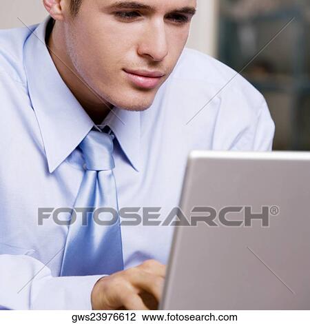 Close-up of a businessman using a laptop View Large Photo Image Stock Image - Close-up of a businessman using a laptop. Fotosearch