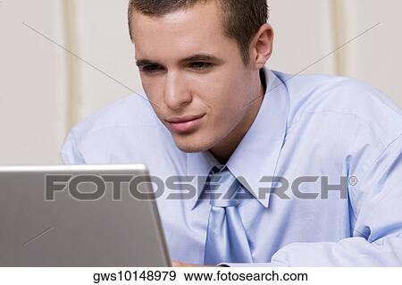 Close-up of a businessman using a laptop View Large Photo Image Stock Photo - Close-up of a businessman using a laptop. Fotosearch