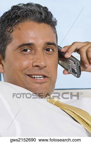 Close-up of a businessman using a mobile phone View Large Photo Image Stock Image - Close-up of a businessman using a mobile phone. Fotosearch