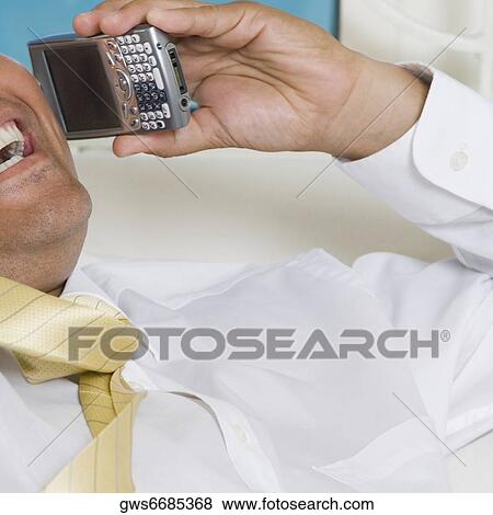 Close-up of a businessman using a mobile phone View Large Photo Image Stock Photo - Close-up of a businessman using a mobile phone. Fotosearch