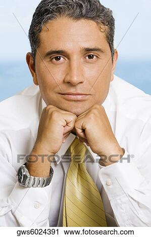 Close-up of a businessman with his hands on his chin View Large Photo Image Stock Image - Close-up of a businessman with his hands on his chin. Fotosearch