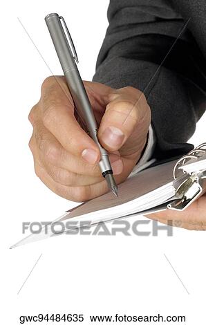 Stock Photography - Close-up of a businessman writing on a spiral notepad. Fotosearch