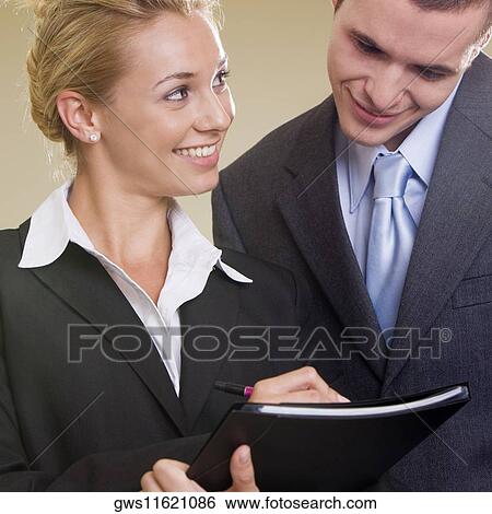 Close-up of a businesswoman and a businessman smiling View Large Photo Image Stock Photograph - Close-up of a businesswoman and a businessman smiling. Fotosearch