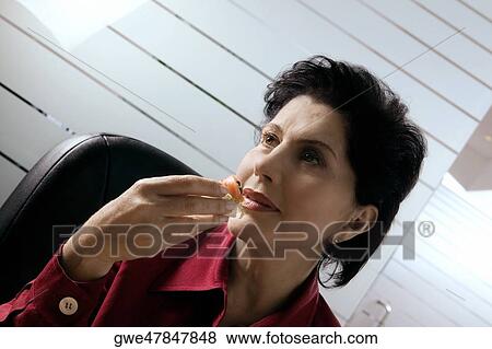 Close-up of a businesswoman having a meal View Large Photo Image Stock Photo - Close-up of a businesswoman having a meal. Fotosearch