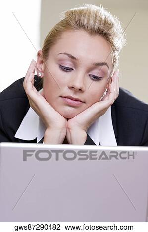 Close-up of a businesswoman in front of a laptop View Large Photo Image Stock Image - Close-up of a businesswoman in front of a laptop. Fotosearch