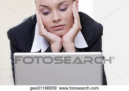 Close-up of a businesswoman in front of a laptop View Large Photo Image Stock Photo - Close-up of a businesswoman in front of a laptop. Fotosearch
