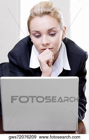 Close-up of a businesswoman in front of a laptop View Large Photo Image Stock Photo - Close-up of a businesswoman in front of a laptop. Fotosearch