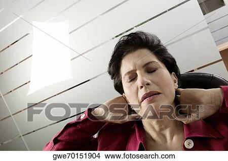 Close-up of a businesswoman massaging her neck View Large Photo Image Picture - Close-up of a businesswoman massaging her neck. Fotosearch