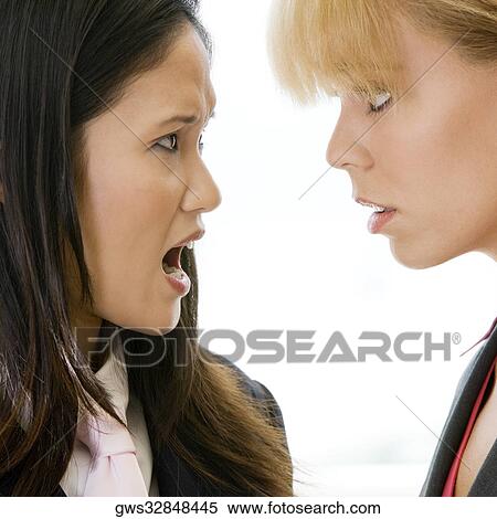 Close-up of a businesswoman scolding another businesswoman View Large Photo Image Stock Photography - Close-up of a businesswoman scolding another businesswoman. Fotosearch