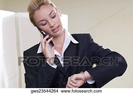 Picture - Close-up of a businesswoman talking on a mobile phone. Fotosearch
