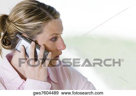 Close-up of a businesswoman talking on a mobile phone View Large Photo Image Stock Photo - Close-up of a businesswoman talking on a mobile phone. Fotosearch