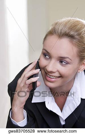 Close-up of a businesswoman talking on a mobile phone View Large Photo Image Stock Photo - Close-up of a businesswoman talking on a mobile phone. Fotosearch