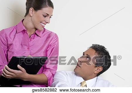 Close-up of a businesswoman talking to a businessman View Large Photo Image Stock Image - Close-up of a businesswoman talking to a businessman. Fotosearch